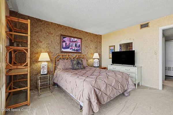 a bedroom with a bed and a television