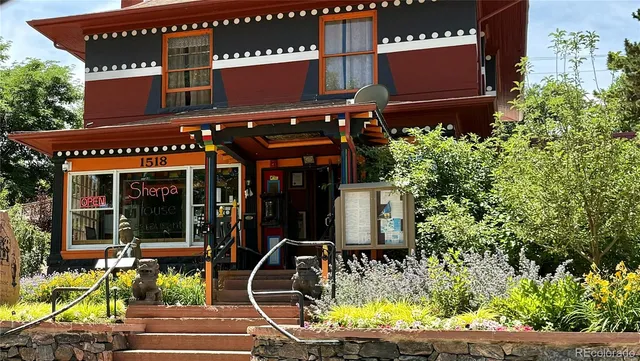 an aerial view of residential houses with outdoor space and street view