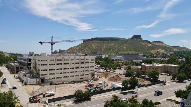 a view of a street with a cars parked on the side of the road