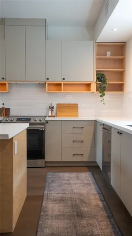 a kitchen with a sink stove and cabinets