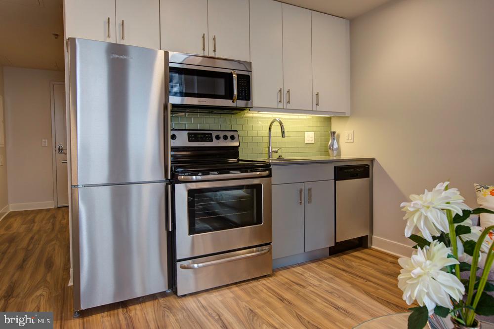 42 South 15th Street, Unit 0B1311 Philadelphia, PA 19102 - Photo 17 of 36 a kitchen with stainless steel appliances a stove a microwave and a refrigerator