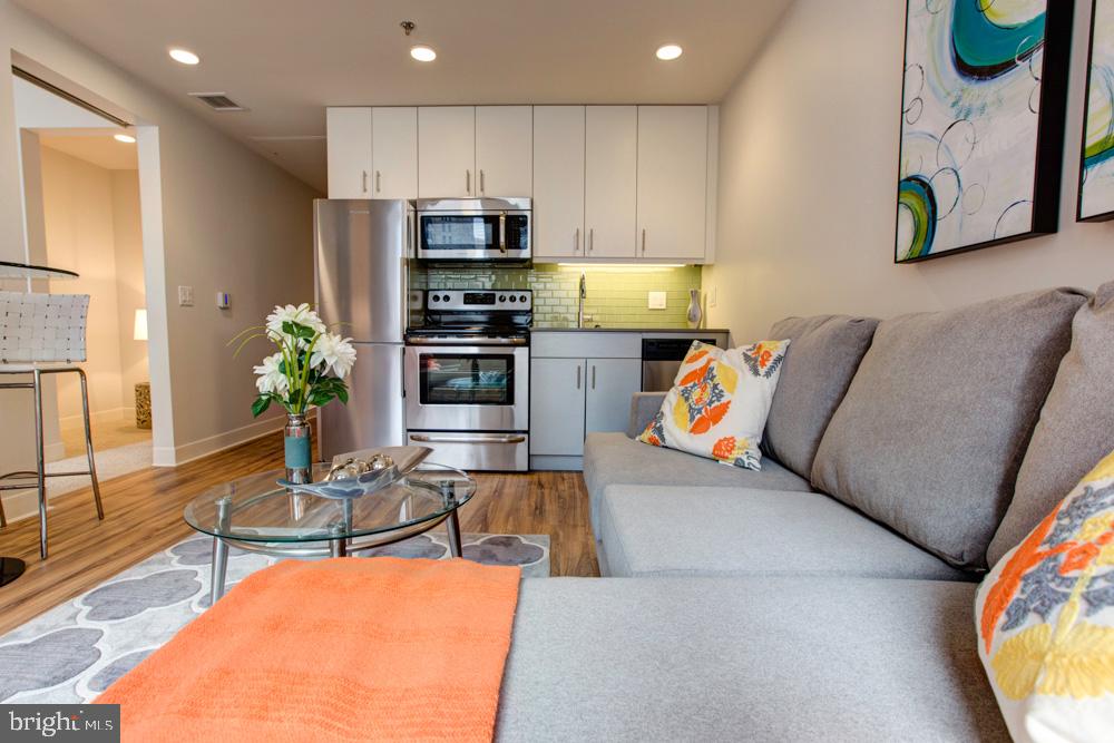 42 South 15th Street, Unit 0B1311 Philadelphia, PA 19102 - Photo 3 of 36 a living room with stainless steel appliances furniture and a kitchen view