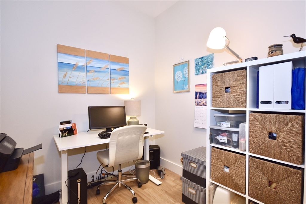 57 Long Point Road, Unit 104 Lakeville, MA 02347 - Photo 13 of 41 a workspace with furniture and wooden floor