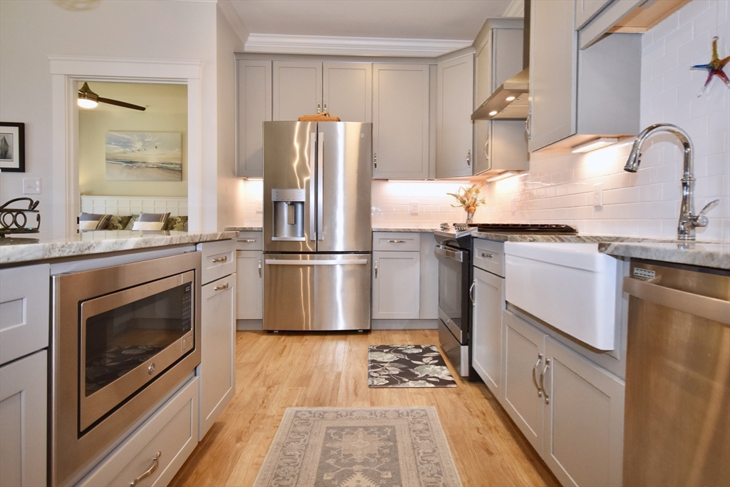 57 Long Point Road, Unit 104 Lakeville, MA 02347 - Photo 16 of 41 a kitchen with granite countertop a refrigerator stove and sink