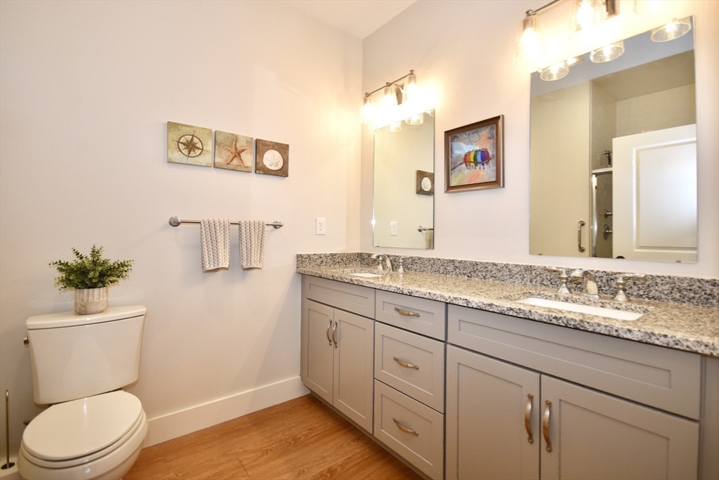 57 Long Point Road, Unit 104 Lakeville, MA 02347 - Photo 19 of 41 a bathroom with a granite countertop toilet sink and mirror