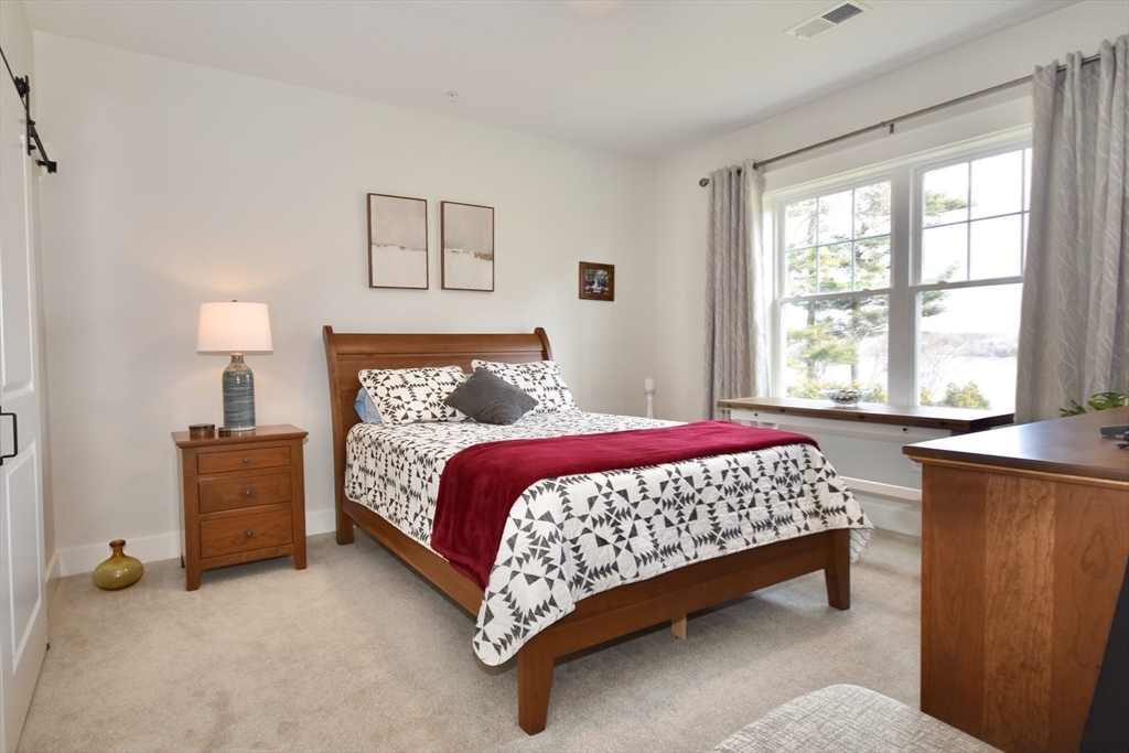 57 Long Point Road, Unit 104 Lakeville, MA 02347 - Photo 22 of 41 a bedroom with a bed and a window