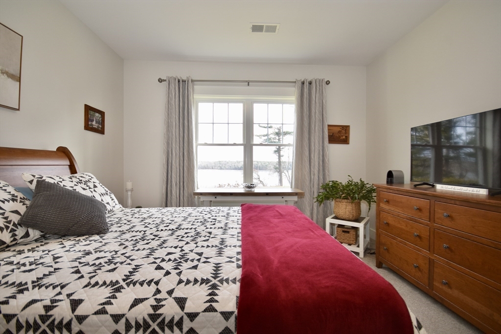 57 Long Point Road, Unit 104 Lakeville, MA 02347 - Photo 23 of 41 a bedroom with a bed and a flat screen tv