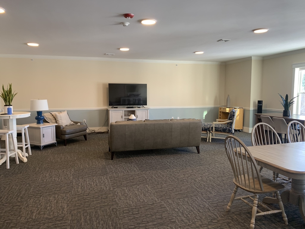 57 Long Point Road, Unit 104 Lakeville, MA 02347 - Photo 40 of 41 a living room with furniture and a flat screen tv