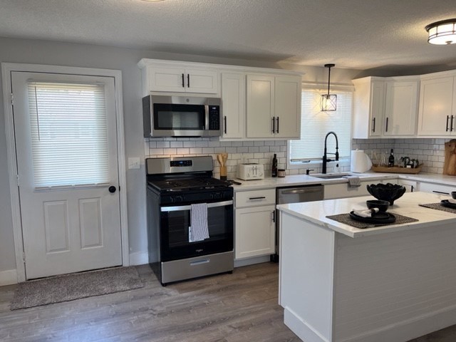 138 Jeffrey Road Springfield, MA 01119 - Photo 6 of 22 a kitchen with stainless steel appliances white cabinets a sink and a stove