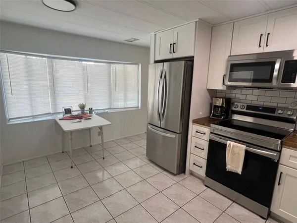 a kitchen with stainless steel appliances a stove a refrigerator and a sink