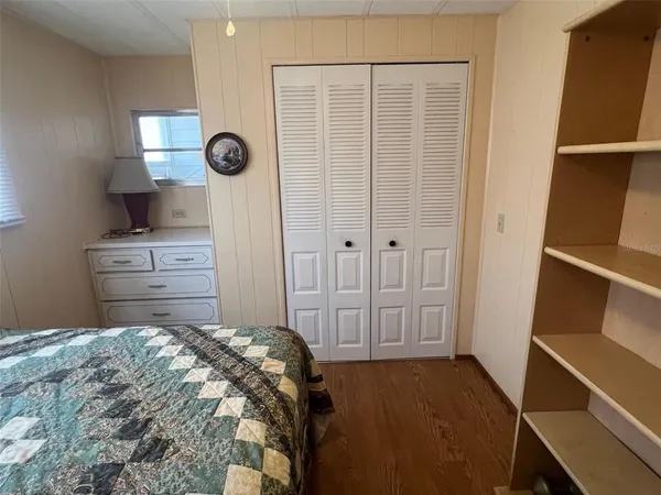a bedroom with a bed and cabinets