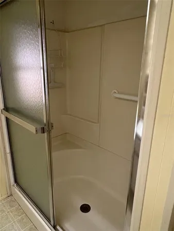 a bathroom with a glass shower door