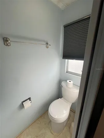 a white toilet sitting next to a bathroom sink