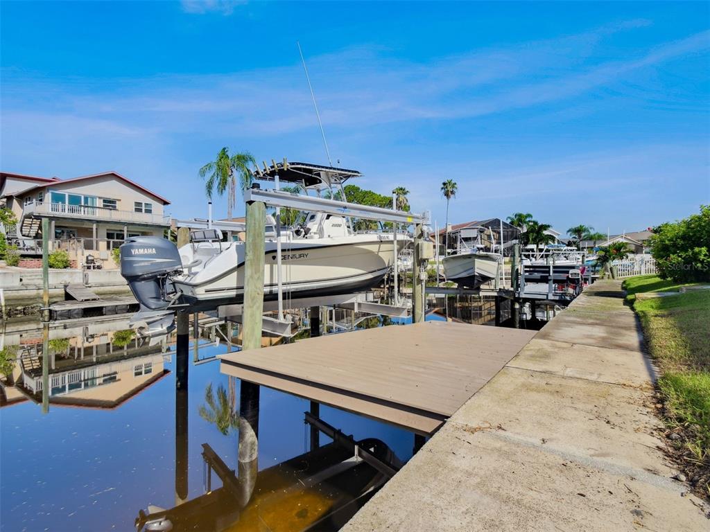 6241 Bayside Drive New Port Richey, FL 34652 - Photo 51 of 78 a roof deck with table and chairs a barbeque