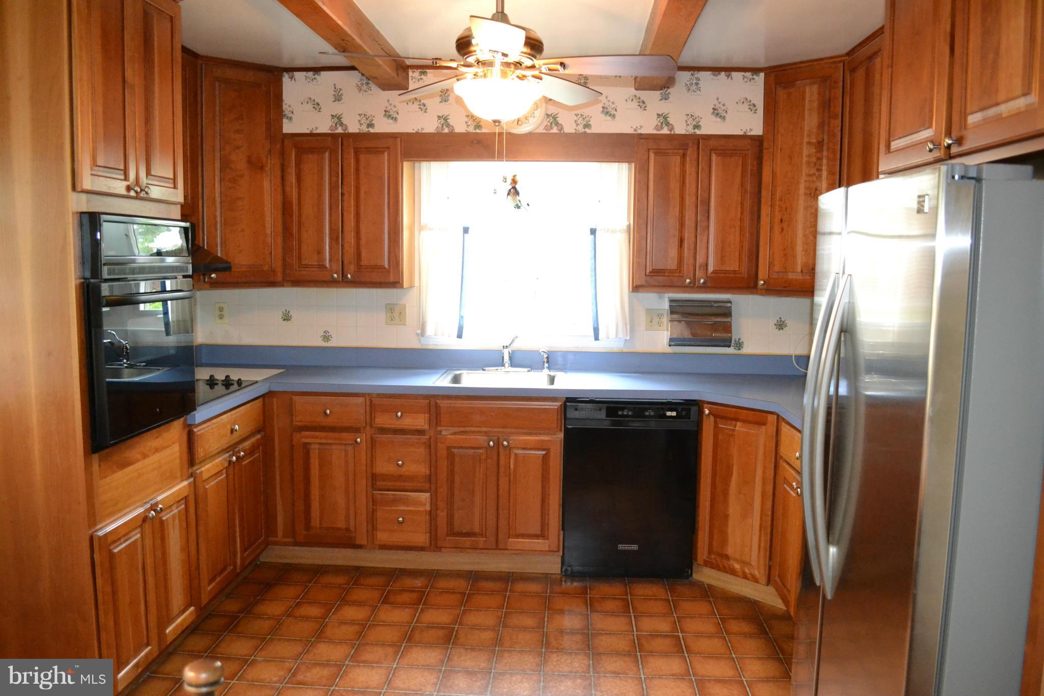 7911 Springway Road Baltimore, MD 21204 - Photo 9 of 30 a kitchen with stainless steel appliances granite countertop a refrigerator and a sink