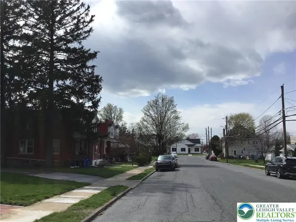 a view of street with parked cars
