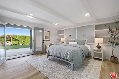 a bed room with a bed and chair