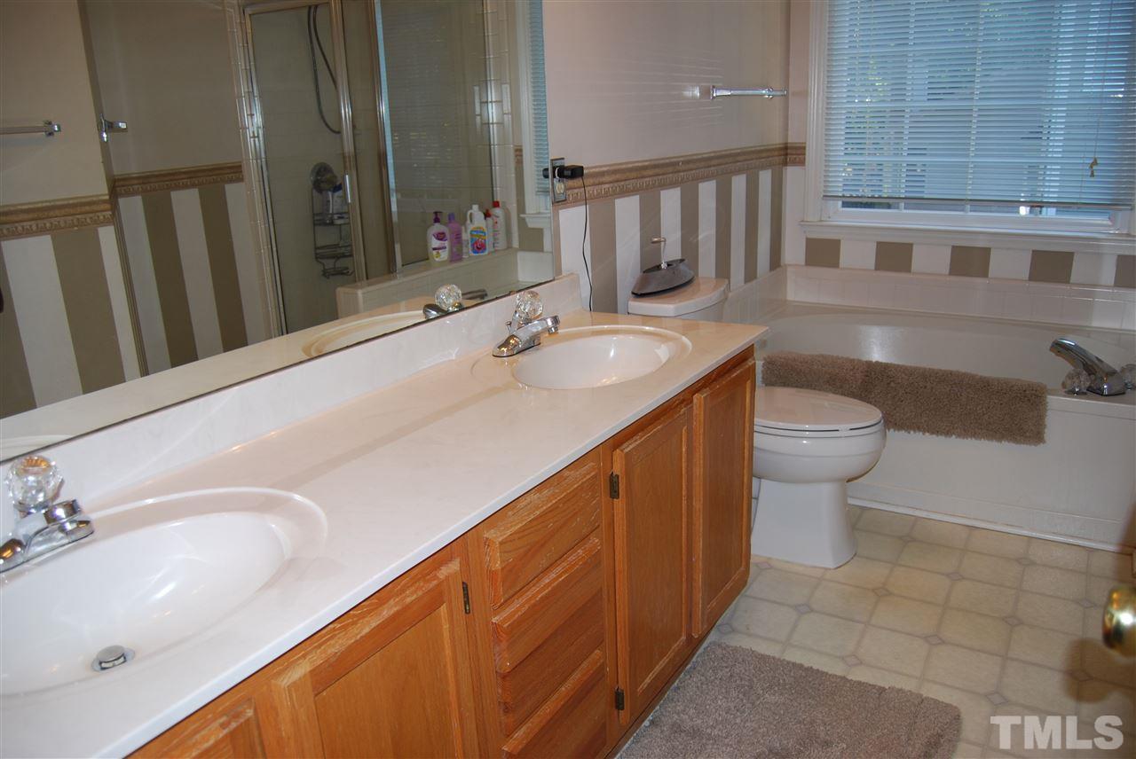 12301 Inglehurst Drive Raleigh, NC 27613 - Photo 15 of 23 a bathroom with a double vanity sink and a mirror