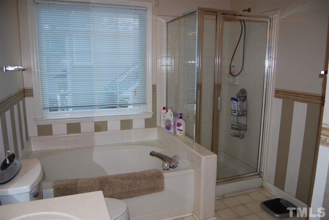 12301 Inglehurst Drive Raleigh, NC 27613 - Photo 16 of 23 a bathroom with a shower and a toilet