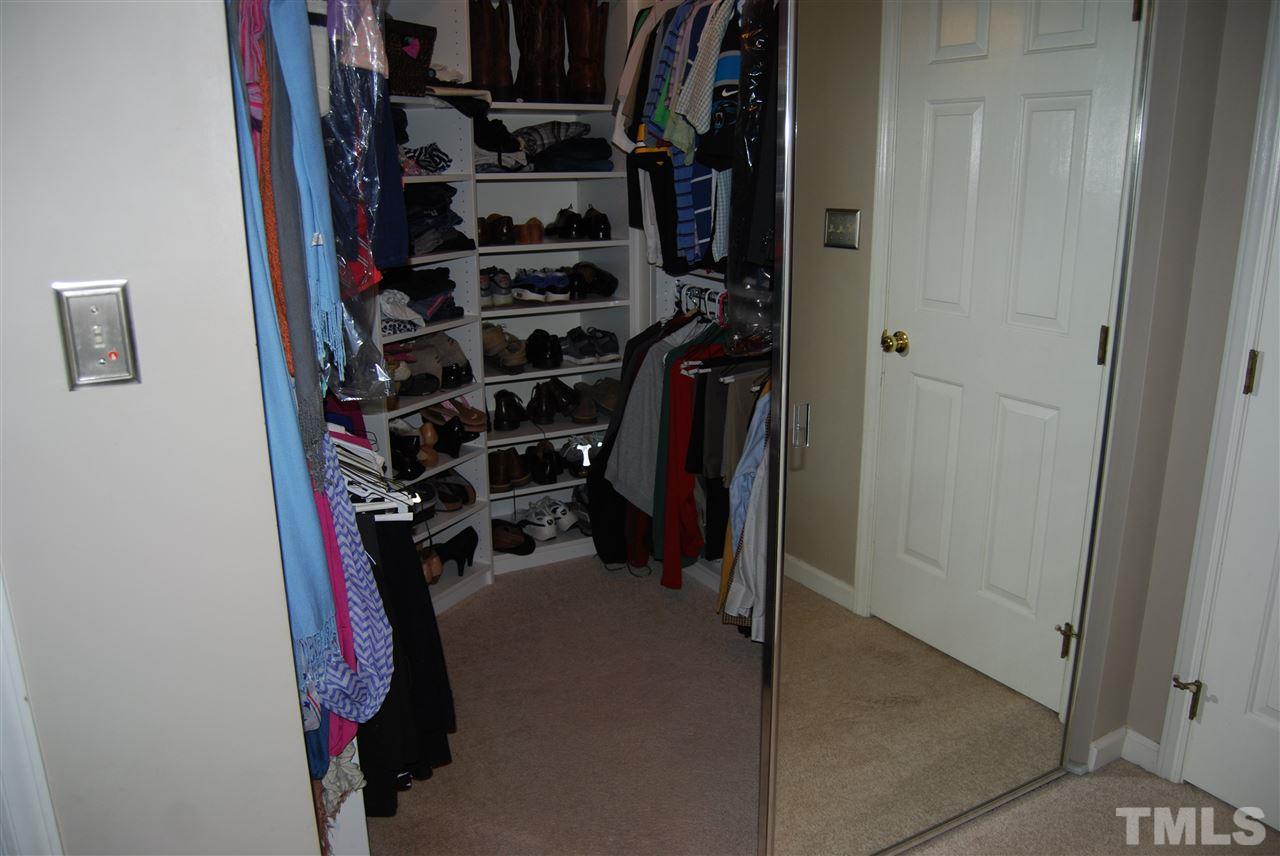 12301 Inglehurst Drive Raleigh, NC 27613 - Photo 17 of 23 a view of walk in closet with clothes and shoes