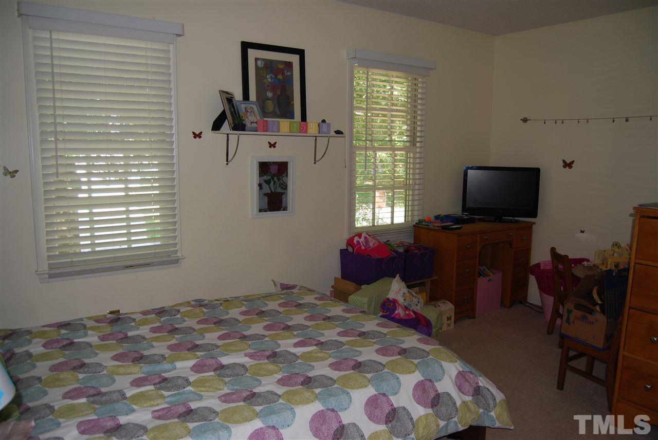 12301 Inglehurst Drive Raleigh, NC 27613 - Photo 18 of 23 a bedroom with a bed and flat screen tv