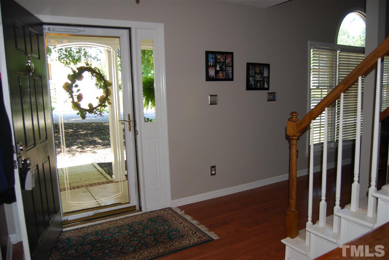 12301 Inglehurst Drive Raleigh, NC 27613 - Photo 3 of 23 a view of entryway with wooden floor and door