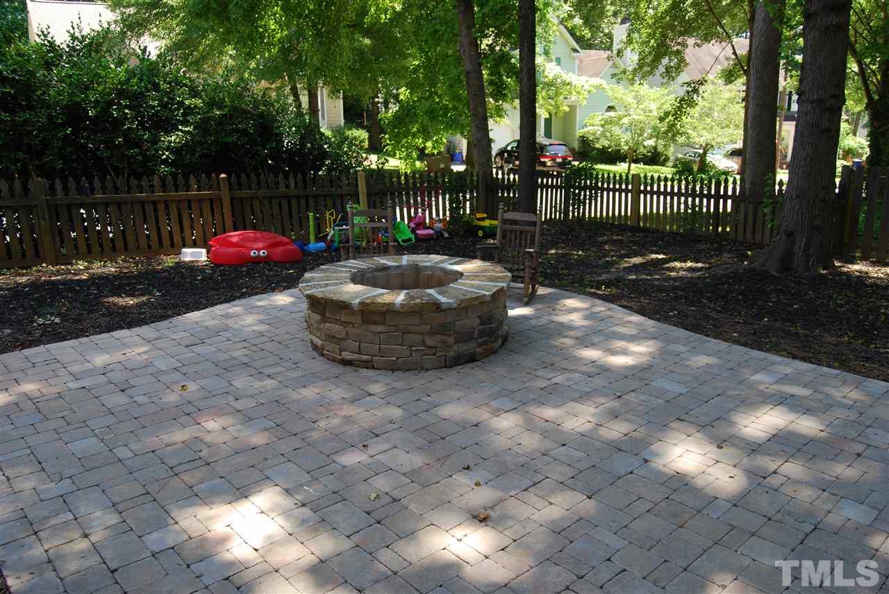 12301 Inglehurst Drive Raleigh, NC 27613 - Photo 21 of 23 a backyard of a house with table and chairs and potted plants