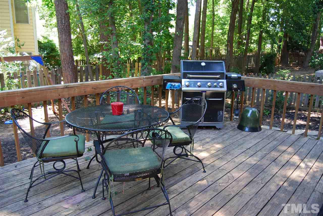 12301 Inglehurst Drive Raleigh, NC 27613 - Photo 23 of 23 a table and chairs in front of a wooden deck