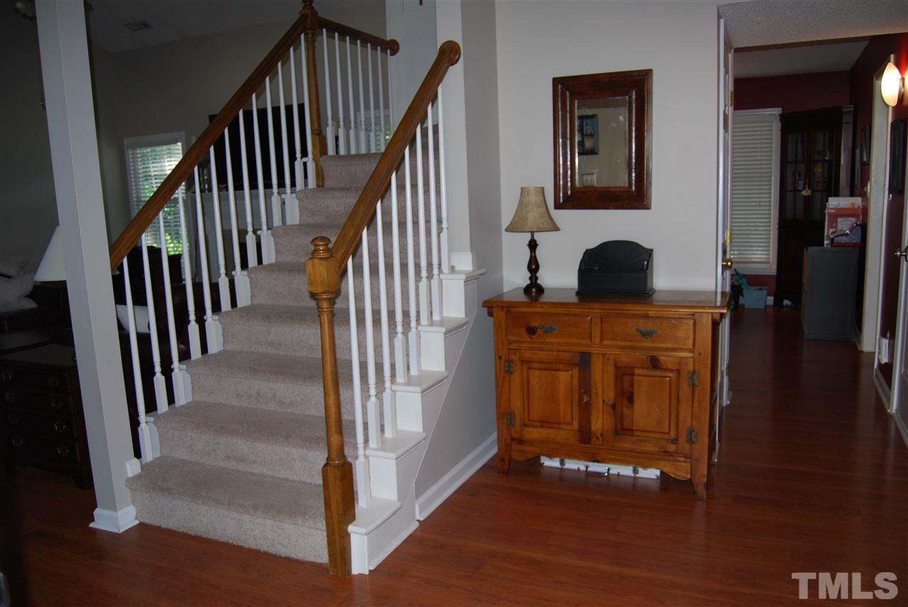 12301 Inglehurst Drive Raleigh, NC 27613 - Photo 4 of 23 a view of entryway and hall with wooden floor