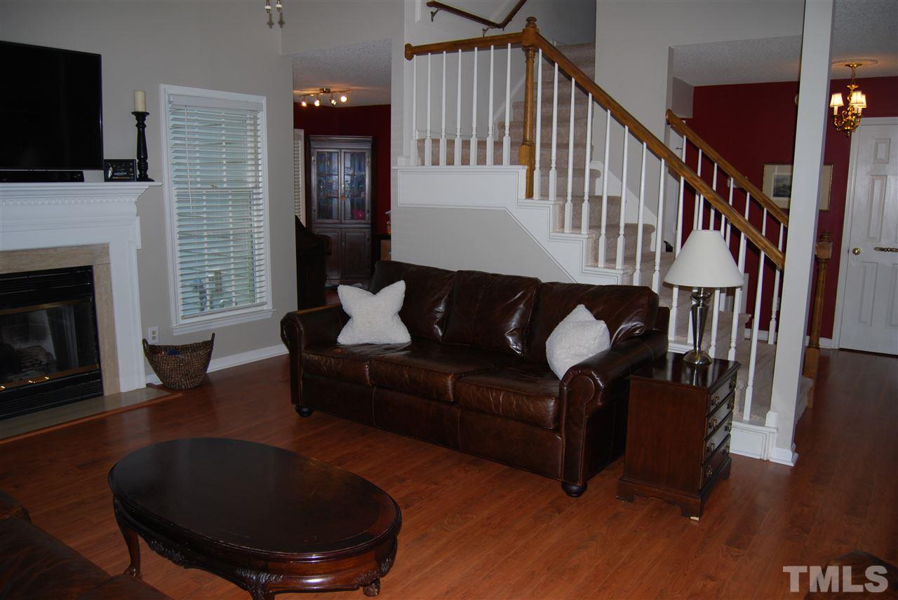 12301 Inglehurst Drive Raleigh, NC 27613 - Photo 5 of 23 a living room with furniture fireplace and flat screen tv