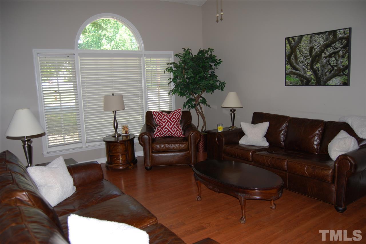 12301 Inglehurst Drive Raleigh, NC 27613 - Photo 8 of 23 a living room with furniture and a large window