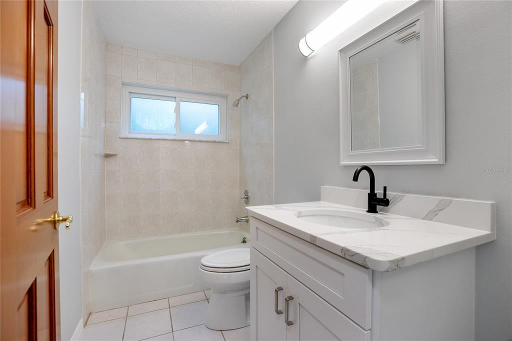 378 Glenwood Road DeLand, FL 32720 - Photo 20 of 38 a bathroom with a sink a toilet and shower