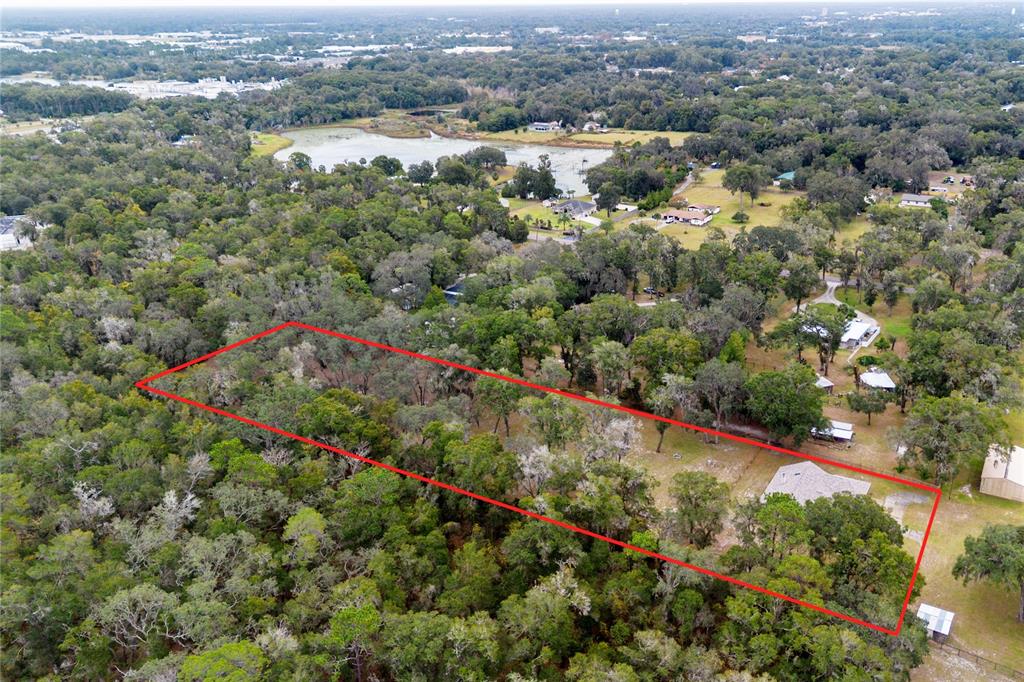 378 Glenwood Road DeLand, FL 32720 - Photo 34 of 38 an aerial view of residential houses with outdoor space and trees