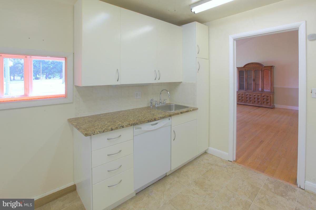 7514 Labyrinth Road Baltimore, MD 21208 - Photo 12 of 27 a kitchen with granite countertop white cabinets and a granite counter tops