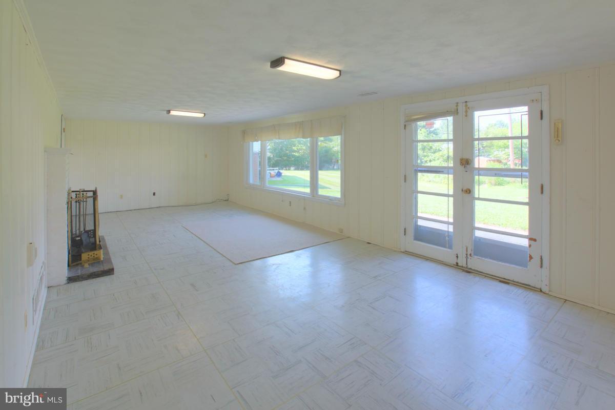 7514 Labyrinth Road Baltimore, MD 21208 - Photo 14 of 27 an empty room with wooden floor and windows