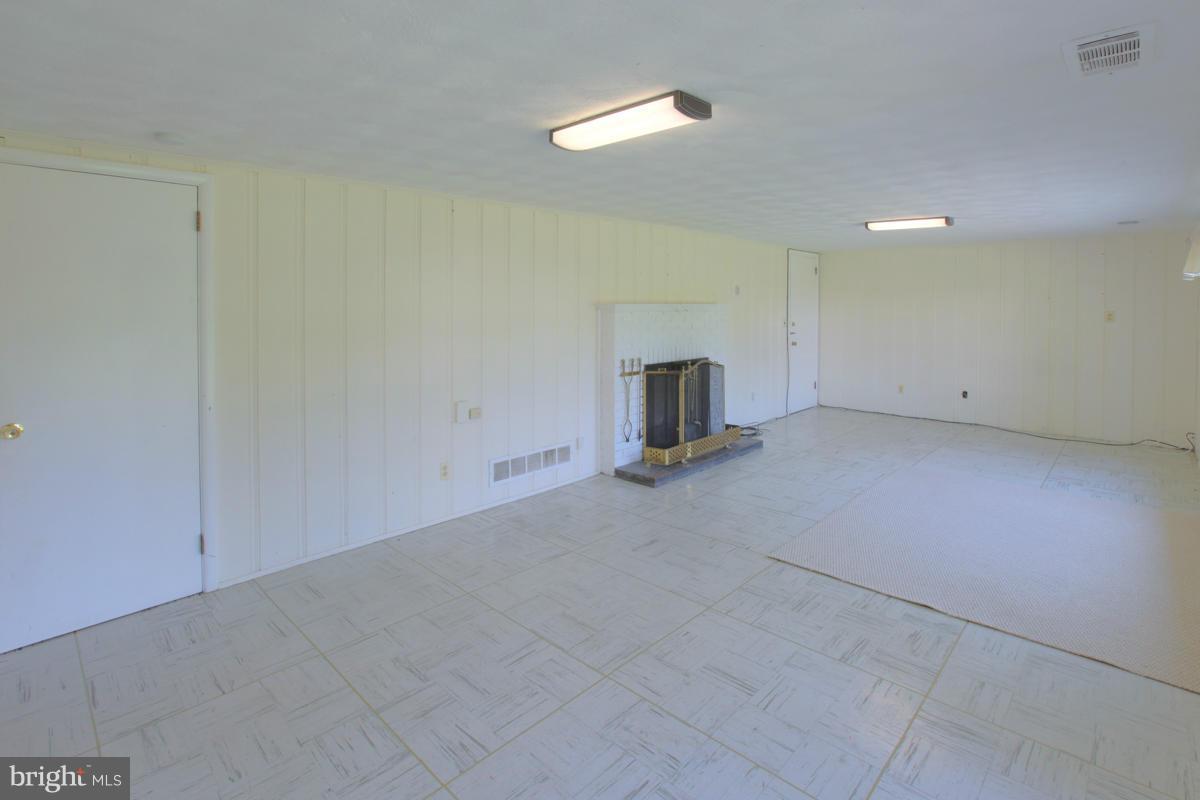 7514 Labyrinth Road Baltimore, MD 21208 - Photo 15 of 27 a view of empty room with a fireplace