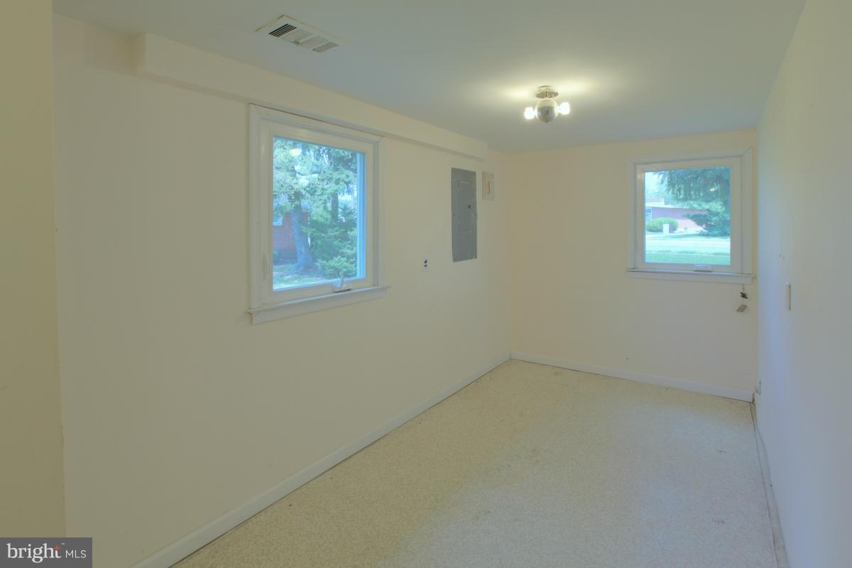 7514 Labyrinth Road Baltimore, MD 21208 - Photo 19 of 27 an empty room with windows