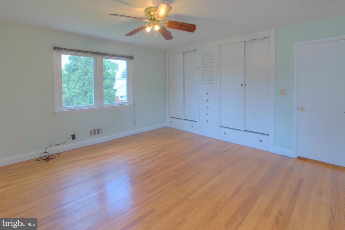 7514 Labyrinth Road Baltimore, MD 21208 - Photo 21 of 27 wooden floor in an empty room with a window