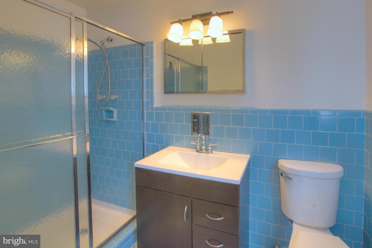 7514 Labyrinth Road Baltimore, MD 21208 - Photo 22 of 27 a bathroom with a toilet sink and mirror