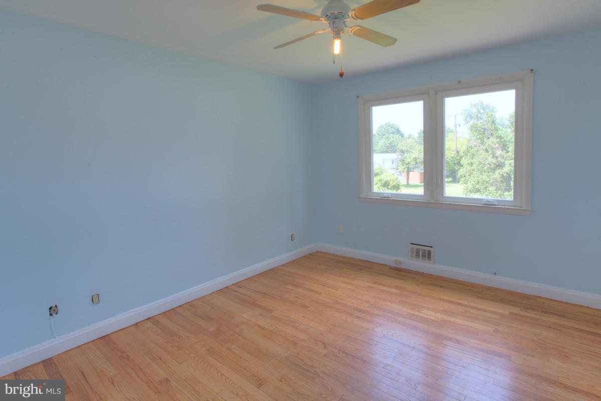7514 Labyrinth Road Baltimore, MD 21208 - Photo 24 of 27 an empty room with a window and ceiling fan