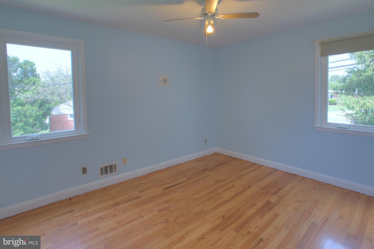 7514 Labyrinth Road Baltimore, MD 21208 - Photo 25 of 27 wooden floor in an empty room with a window