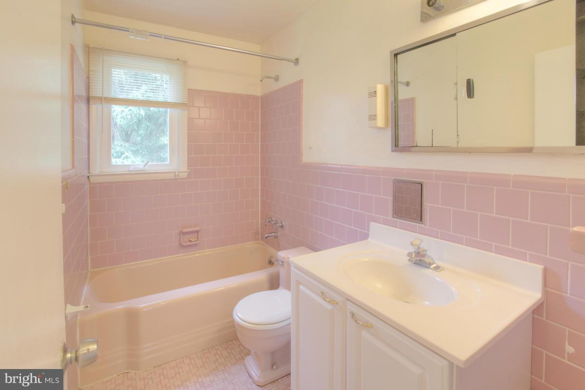 7514 Labyrinth Road Baltimore, MD 21208 - Photo 26 of 27 a bathroom with a sink a toilet and bathtub