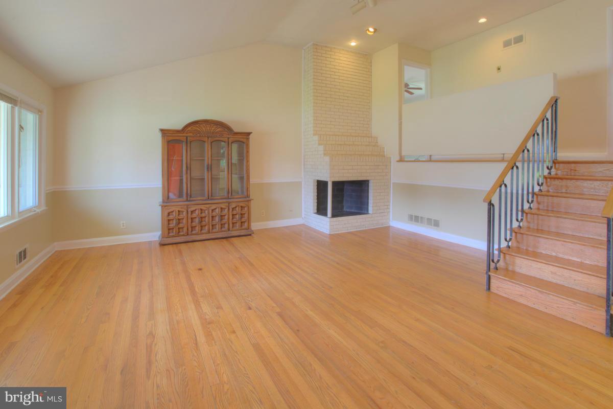 7514 Labyrinth Road Baltimore, MD 21208 - Photo 5 of 27 a view of empty room with wooden floor and fan