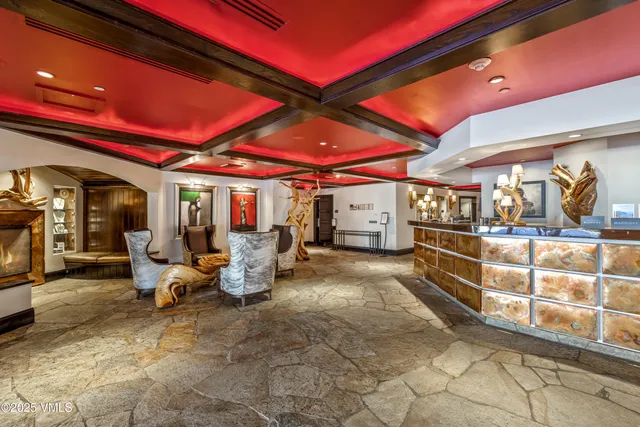 a living room with furniture a rug and a fireplace