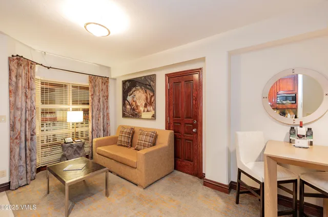 a living room with furniture and a mirror