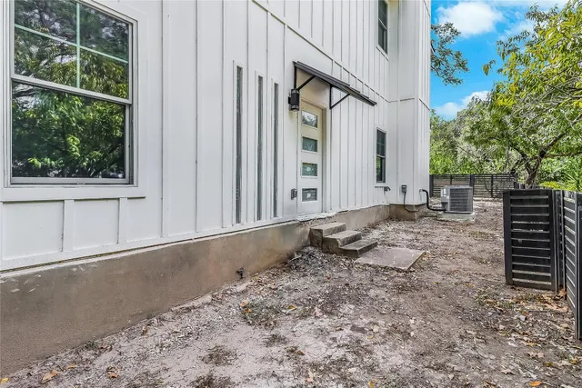 a view of a house with backyard porch and sitting area