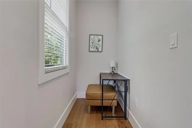 a kitchen with stainless steel appliances kitchen island granite countertop a table chairs in it and wooden floors