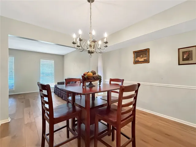 a view of a dining room with furniture and chandelier