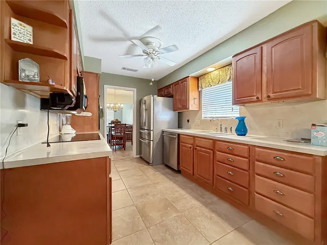 a kitchen with a sink a stove and cabinets