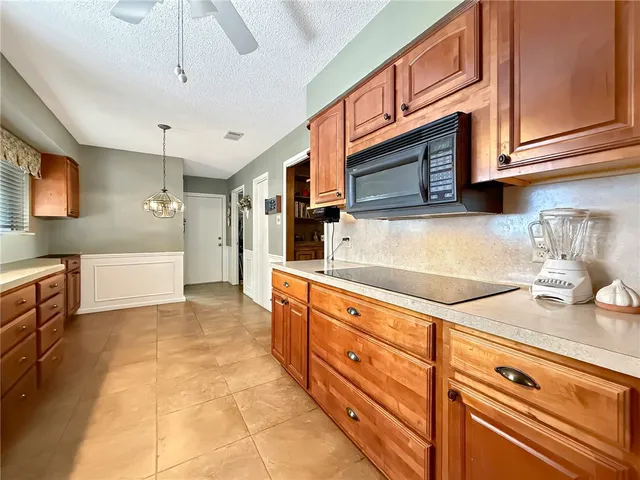 a kitchen with stainless steel appliances granite countertop a sink and cabinets